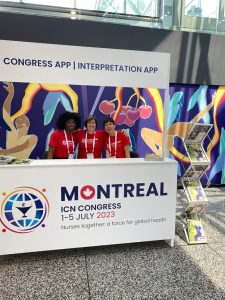 Three volunteers at Booth at ICN Congress.
